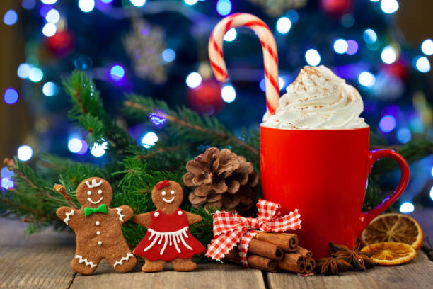 istock Christmas cappuccino and gingerbread cookies infront Christmas tree 1351938735