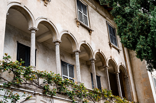 Terrace with ivy-covered arches. Villa Monastero, Italy. High quality photo