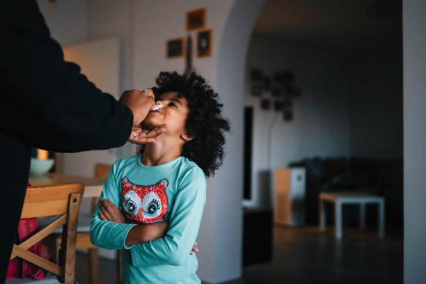 istock Mom wiping her daughters lips after breakfast 1351940858