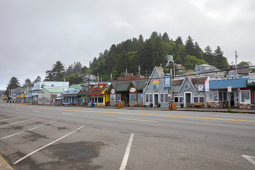 Depoe Bay, Oregon, USA - July 1, 2021: Depoe Bay oceanfront shops and restaurants on highway 101 early in the morning before most of the businesses open.