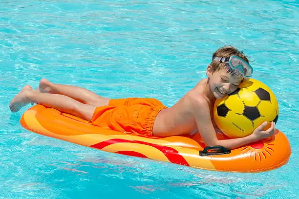 Photo of Boy on lilo in pool