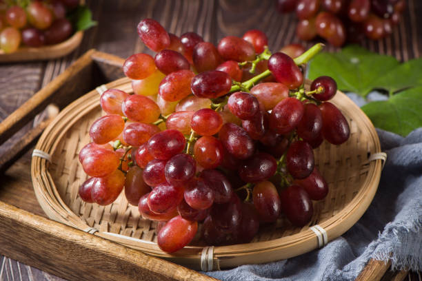 istock fresh ripe red seedless grapes  on wood table 1351951134