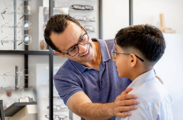 istock Indian father and son choosing eyeglasses in optics store 1351952129
