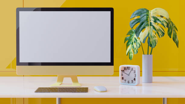 istock Yellow computer monitor on white desk 1351957542