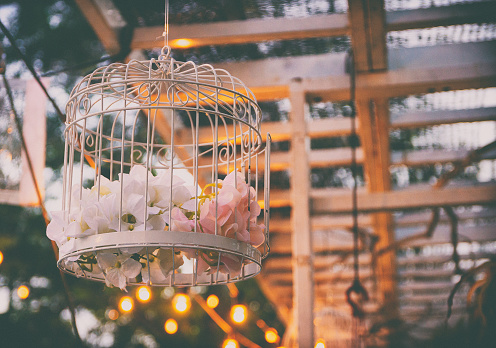 Outdoor birdcage with floral decoration