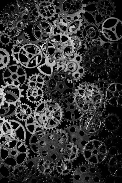 istock Cogs and watch pieces on black background metal wheels 1351960805