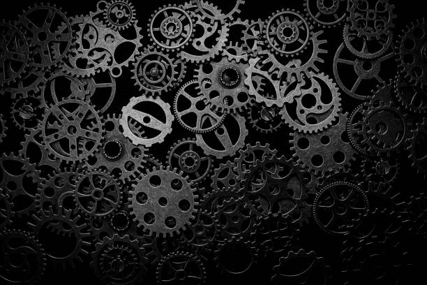 istock Cogs and watch pieces on black background metal wheels 1351960868