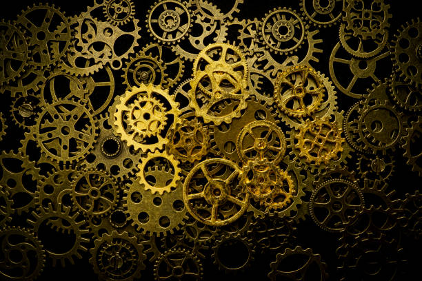 istock Cogs and watch pieces on black background metal wheels 1351960873