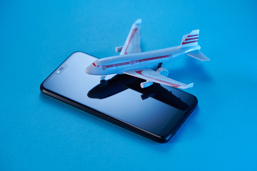 Top view photo of toy airplane model on smartphone