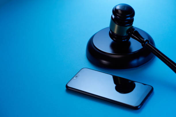 istock gavel hammer  with smartphone on blue background. Justice and law concept. 1351965002