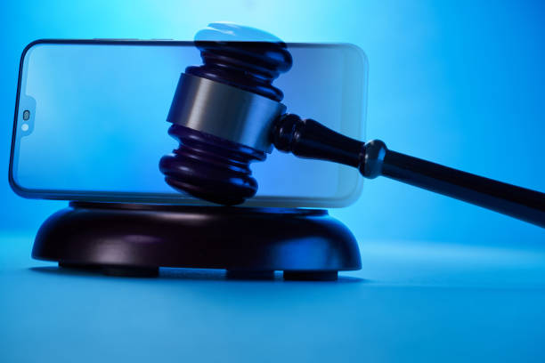 istock gavel hammer  with smartphone on blue background. Justice and law concept. 1351965007