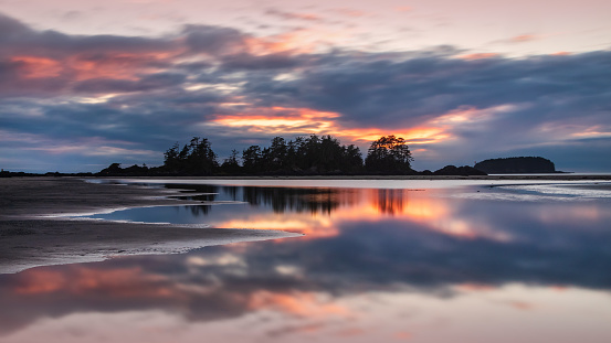 Sunset reflections along the shoreline of Chesterman Beach, Tofino, British Colombia.