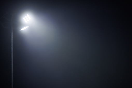 lamp post with two led lamps at foggy night.