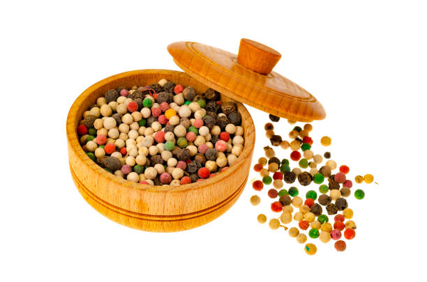 Dry colored peppercorns in wooden form. Studio Photo