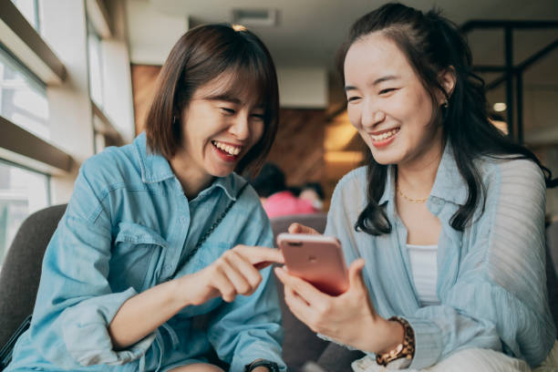 istock Young ladies gossiping in cafe 1351968130