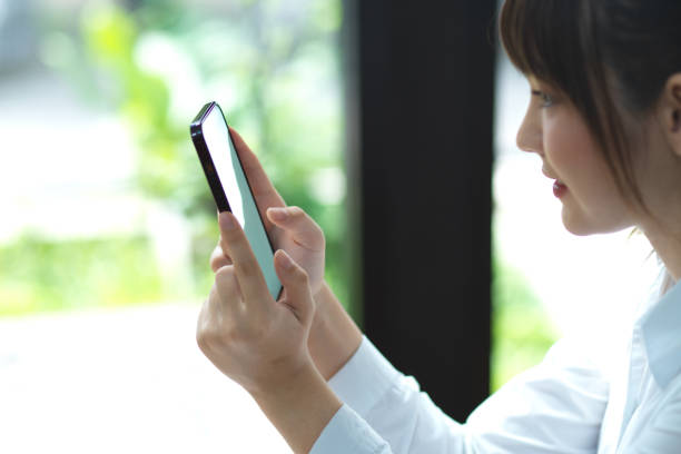 istock Pretty millennial female using mobile phone 1351971200