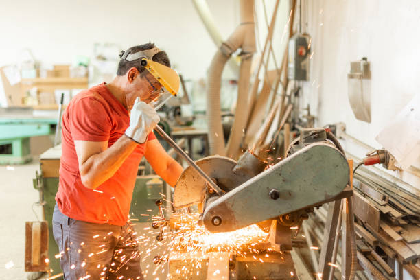 istock Adult man working with an iron cutter, sparks flying 1351972068