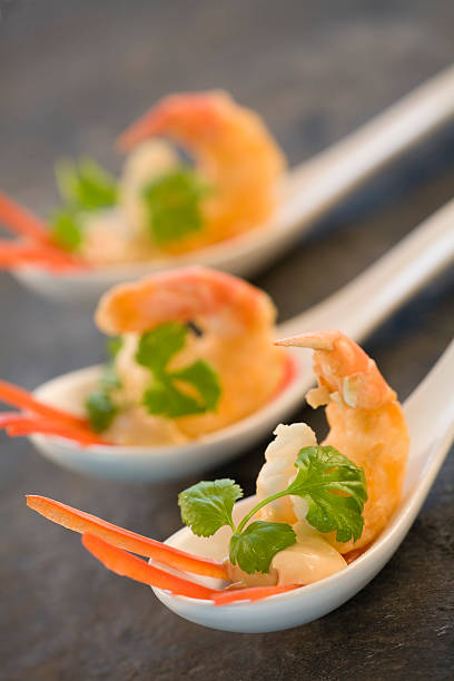 spoons filled with shrimp stock photo