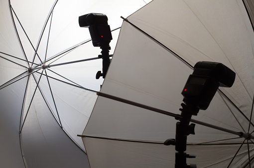 Studio equipment for photography. Photo flashes and umbrellas for studio lighting.