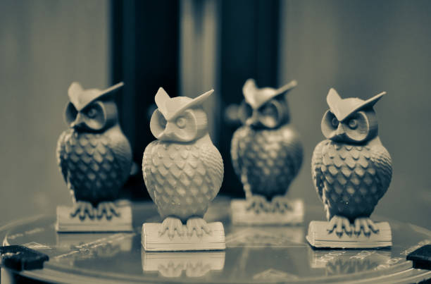 istock Four multicolored models of owls created on a 3d printer stand close-up 1351982159