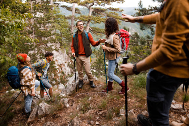 istock Cheerful backpackers talking on a rocky mountain. 1351985544