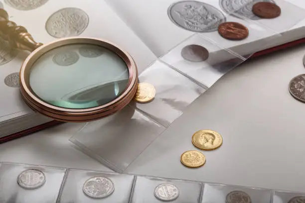 Photo of Numismatics. Old collectible coins on a table. light background.