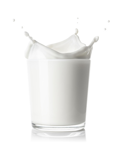 glass of milk with splash crown isolated on white background