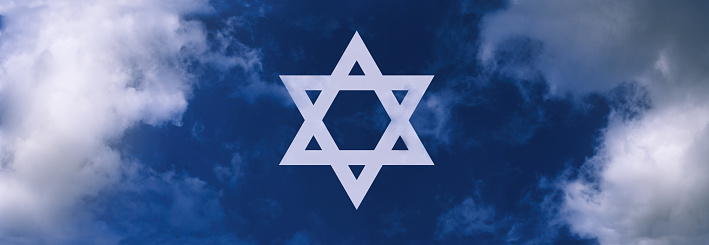 Symbol of Israel in the sky amongst clouds during a bright day.