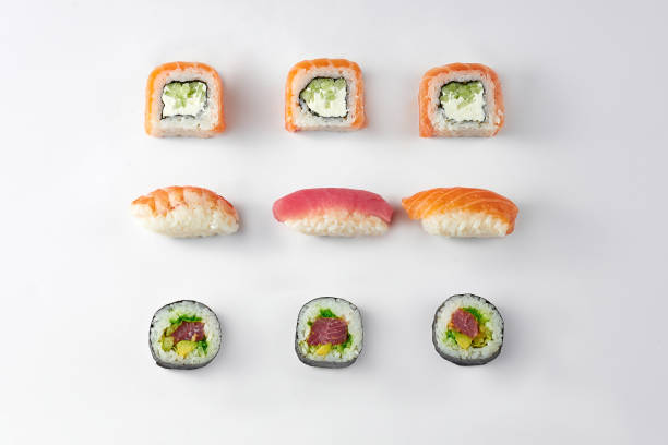 istock Pattern of different types of sushi rolls with tuna and salmon on a white background 1351991593