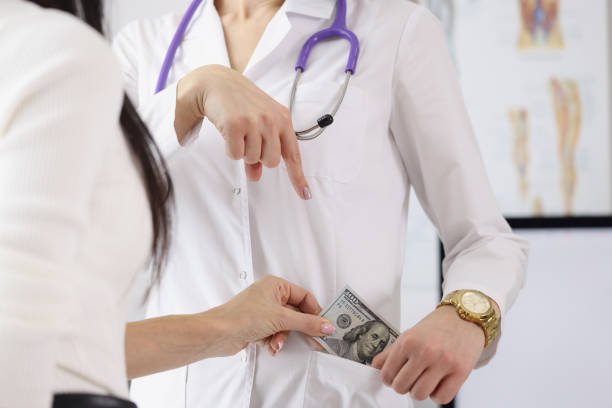 istock Doctor taking money bribe 1351991962
