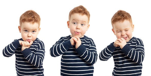 Set of portraits of cute little red haired boy grimacing at the camera