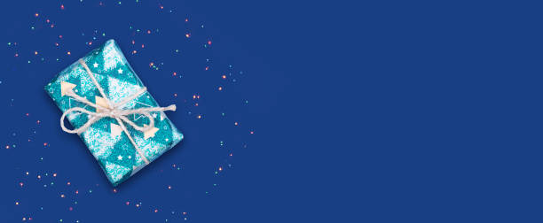 istock New Year's gift on a blue background. New year banner. Copy space. Place for text. Festive background. 1351993241