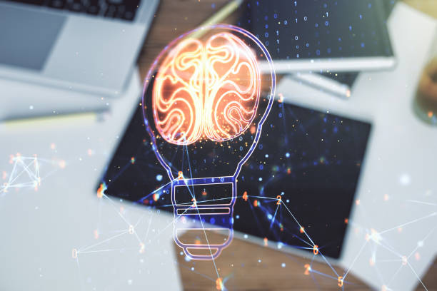istock Creative light bulb with human brain hologram and modern digital tablet on background, artificial Intelligence and neural networks concept. Multiexposure 1351995425