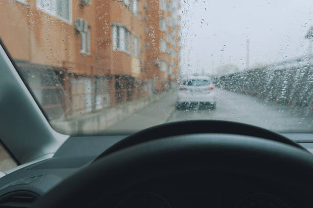 istock POV of rainy cityscape through a car windshield 1351995433