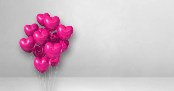 istock Pink heart shape balloons bunch on a white wall background. Horizontal banner. 1351996584