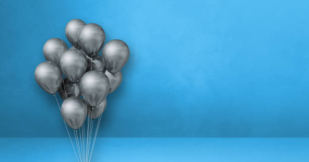 istock Silver balloons bunch on a blue wall background. Horizontal banner. 1351996633