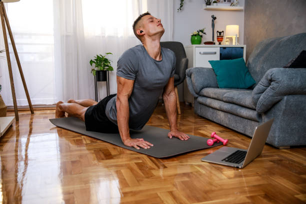 istock Young man stretching his back after finishing a home work 1351997686