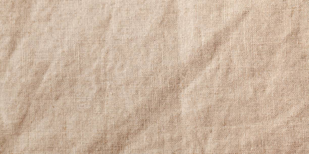 istock Banner beige textile linen tablecloth in full frame. Cloth texture background. Copy space. 1351997763