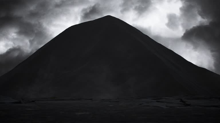 A mystical, dramatic landscape with a large black mountain.