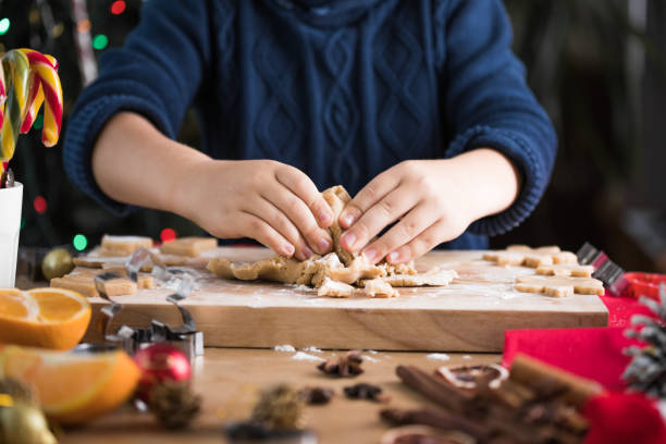 istock Child rolling out dough for christmas cookies 1351997882
