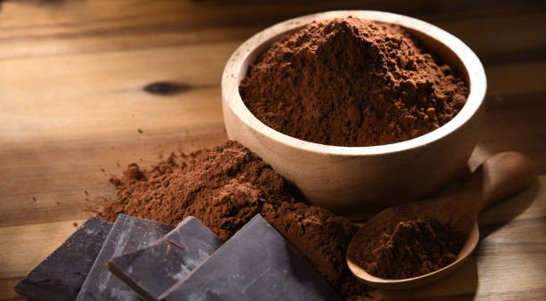 istock Composition with bowl of cocoa powder on wooden table 1351997977