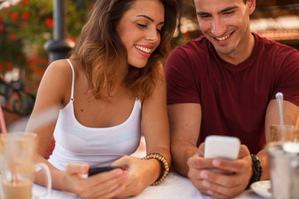 istock Couple using phone app to split a bill at the cafe 1351999197