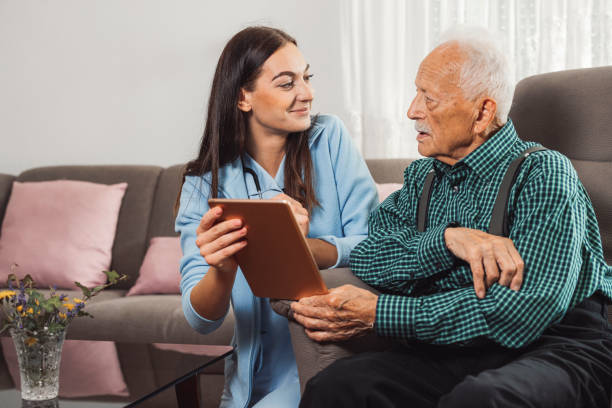 istock Caregiver examining a senior man at home 1352000091