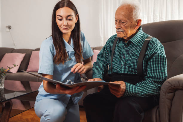 istock Caregiver examining a senior man at home 1352000109