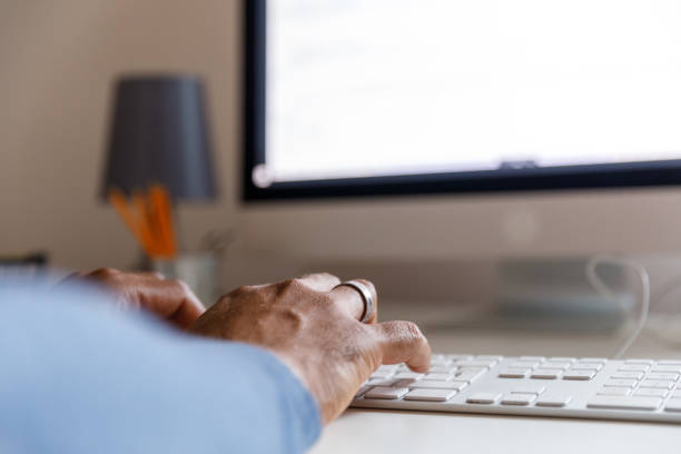 istock Copy space shot of unrecognizable male entrepreneur typing data on computer keyboard 1352000793