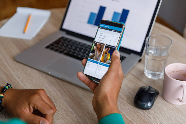 istock Man checking his online banking account via smart phone app 1352001110