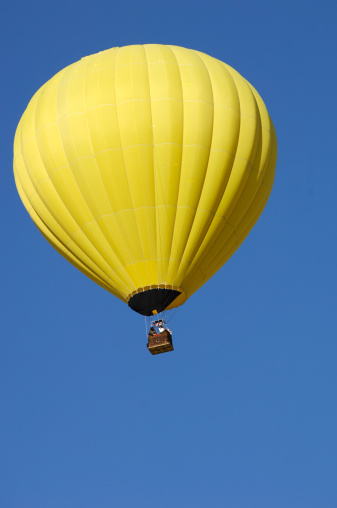 Yellow hot air balloon in the sky.
