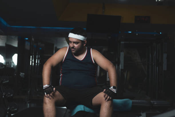 istock a funny chubby young man training inside a gym.concept of effort and improvement. 1352003818
