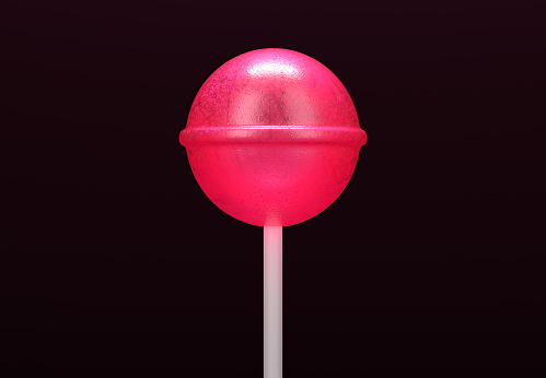 Pink lollipop on stick on black background