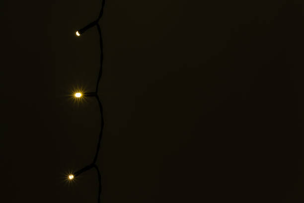 istock Garland. Christmas tree lights on dark wall. 1352004235
